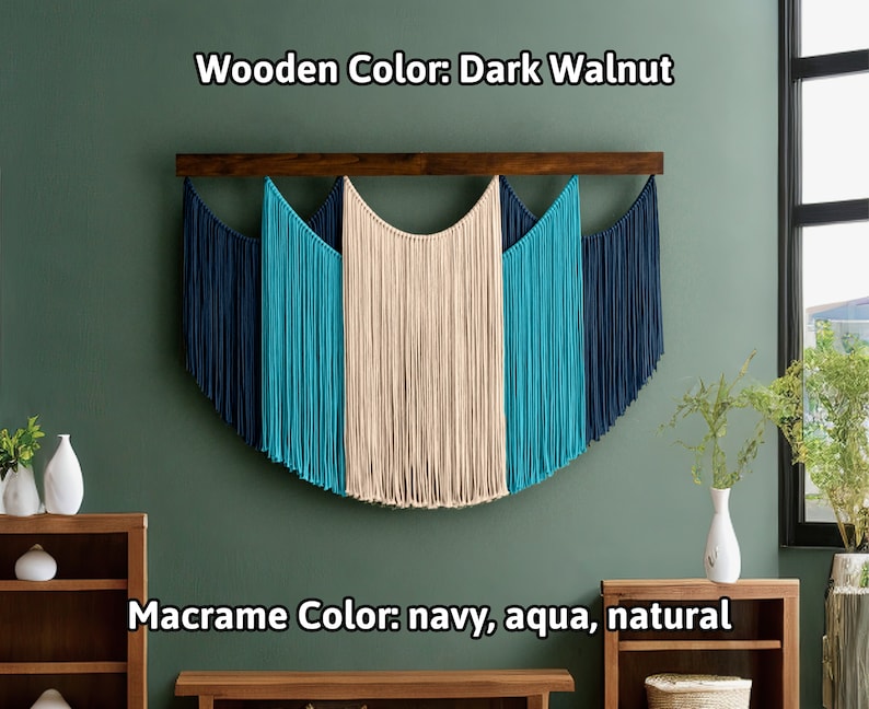 May include: A macrame wall hanging with a dark walnut wooden bar. The macrame features navy, aqua, and natural colored cords, creating a semi-circular design. The text on the image reads "Wooden Color: Dark Walnut" and "Macrame Color: navy, aqua, natural."