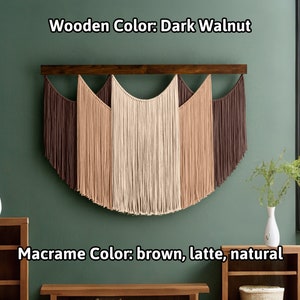 May include: A macrame wall hanging with a dark walnut wooden bar. The macrame features a half-circle design with brown, latte, and natural colored fringe. The text in the image reads "Wooden Color: Dark Walnut" and "Macrame Color: brown, latte, natural."