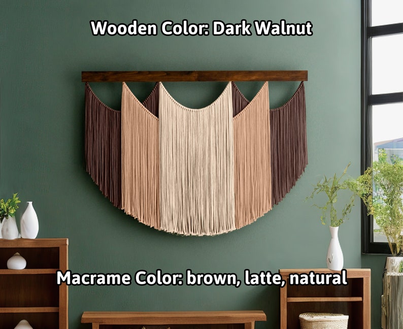May include: A macrame wall hanging with a dark walnut wooden bar. The macrame features a half-circle design with brown, latte, and natural colored fringe. The text in the image reads "Wooden Color: Dark Walnut" and "Macrame Color: brown, latte, natural."