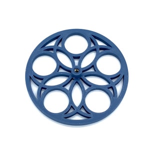 Könnte beinhalten: Ein blaues Plastikrad mit einem geometrischen Design mit sechs runden Ausschnitten. Das Rad hat eine kleine Metallschraube in der Mitte.