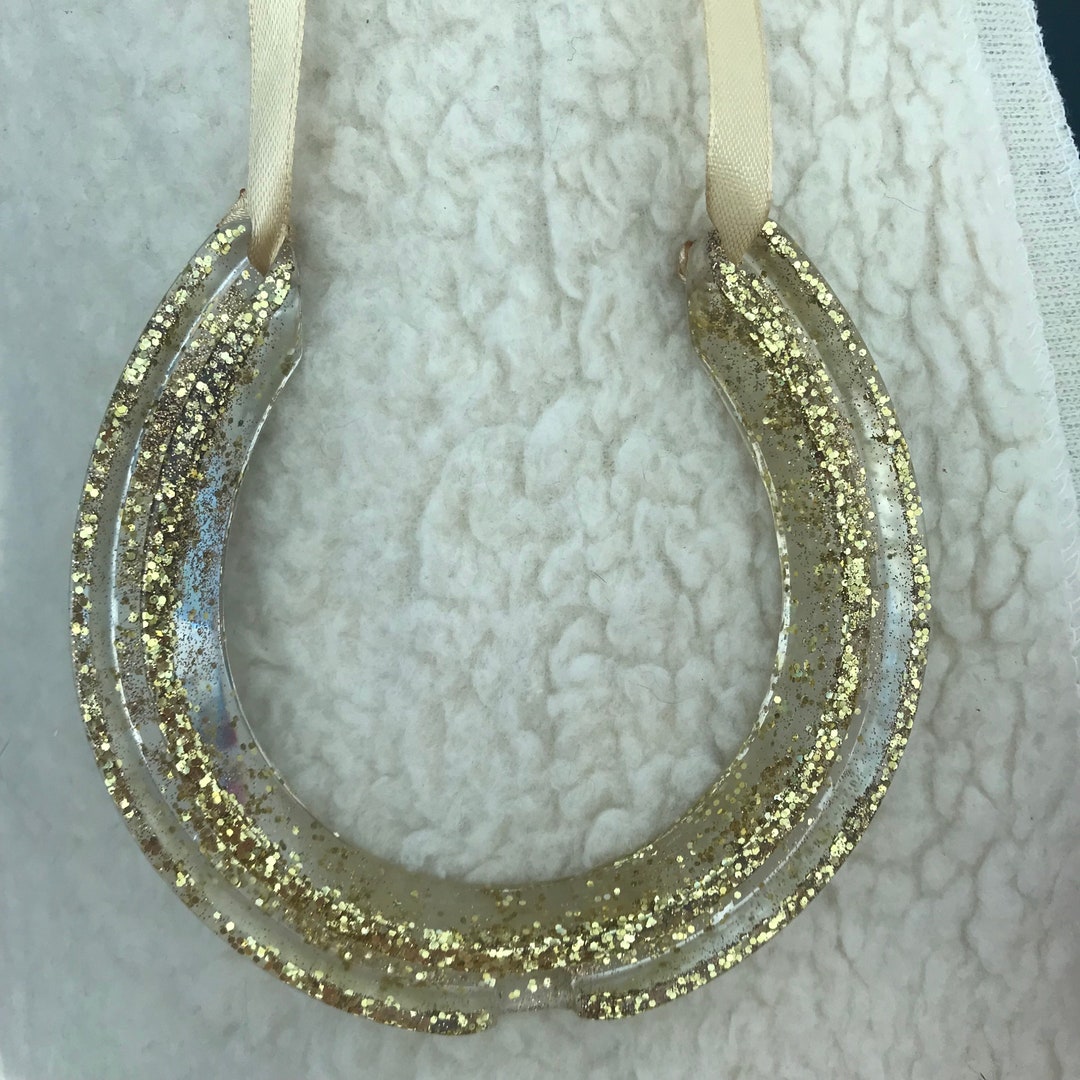 A Resin Horseshoe Made Using Flowers, Foliage, Glitter and More. the