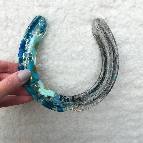 A resin horseshoe which is custom made. These are unique keepsakes for horses and pets, and also make great gifts for birthdays and weddings