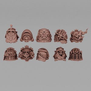 May include: A collection of ten detailed, tan-colored shoulder pads, each with unique designs. The designs include skulls, crosses, and other ornate, gothic-inspired elements. The shoulder pads are arranged on a neutral gray background.