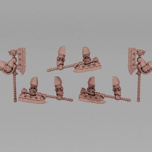 May include: Several small, light brown miniature axes are arranged on a gray background. Each axe has a detailed design, including a blade, handle, and decorative elements. The axes appear to be made of plastic.