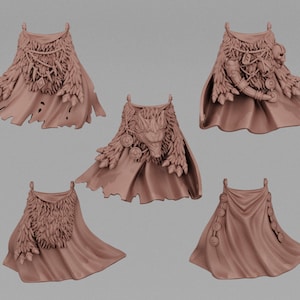 May include: Five different styles of brown leather capes with various embellishments, including feathers, beads, and metal accents. The capes are all made of a soft, supple leather and have a distressed look.