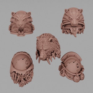May include: Five different 3D printed plastic miniatures of wolf heads. The miniatures are painted in a light brown color. The wolf heads are all different designs, with some having more detail than others.