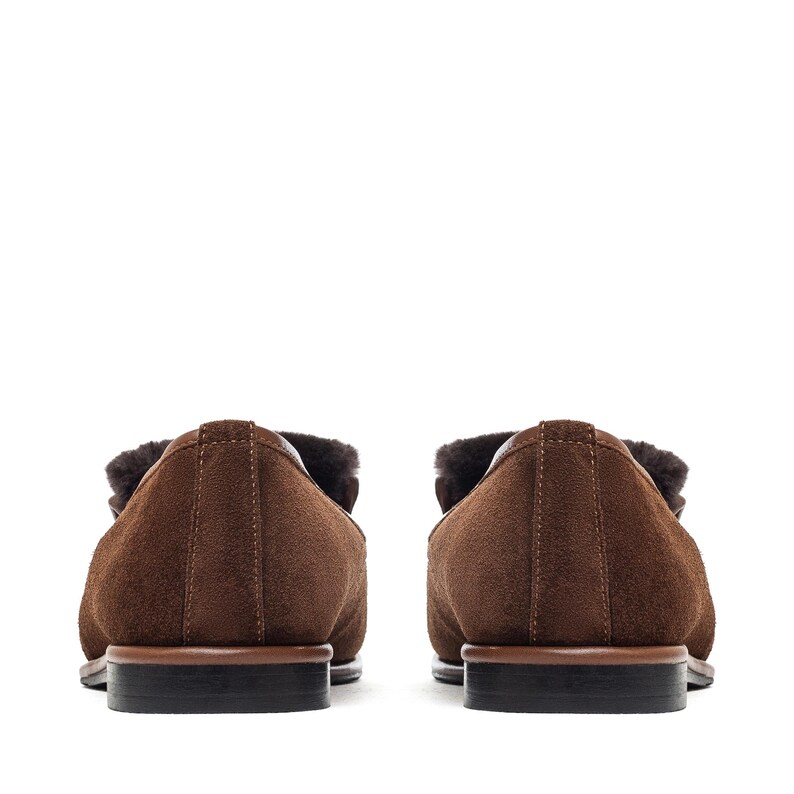 May include: A pair of brown suede loafers with a shearling lining. The shoes have a classic design with a rounded toe and a low heel. The soles are dark brown with a black heel.
