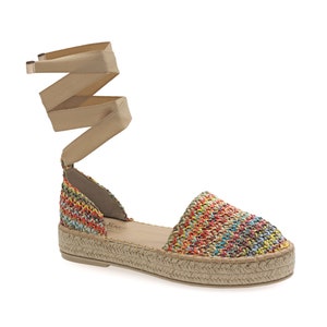 May include: Espadrille sandals with a woven multi-color upper and a beige ankle wrap. The sole is made of woven jute. The sandals have a low platform and a rounded toe.