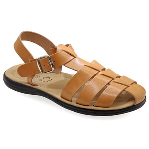 May include: Tan leather sandal with a woven design across the top. The sandal has a black sole, a buckle closure, and a strap around the ankle. The sandal is designed for comfort and style.