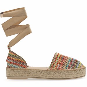 May include: A colorful espadrille sandal with a woven upper in shades of red, yellow, blue, and green. The platform sole is made of woven jute. The sandal features a beige fabric ankle wrap with a buckle closure.