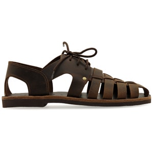 May include: Brown leather sandal with a woven design across the foot. The sandal features a lace-up closure and a sturdy sole. The open design and rich brown color suggest a casual, comfortable style. The sandal is designed for warm weather.