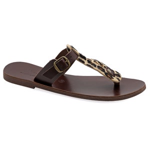 May include: Brown leather sandals with a leopard print strap and buckle closure.