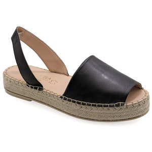May include: Black leather espadrille sandals with a slingback strap and a jute platform sole.
