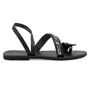 May include: Black leather sandals with a silver strap and a toe loop.