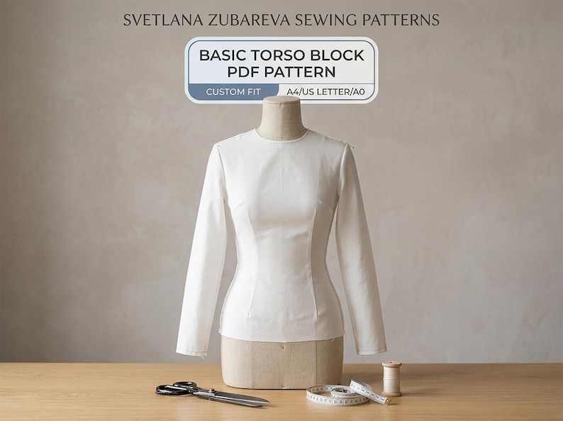 May include: A white long-sleeve top on a dress form with text reading SVETLANA ZUBAREVA SEWING PATTERNS, BASIC TORSO BLOCK PDF PATTERN, CUSTOM FIT, A4/US LETTER/A0. Includes sewing scissors, a coiled measuring tape, and a wooden thread spool.