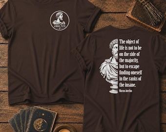 May include: A dark brown t-shirt featuring a white circular graphic on the chest with a bust of Marcus Aurelius and the text Amor Fati. The back displays a white graphic of a bust and the quote The object of life is not to be on the side of the majority, but to escape finding oneself in the ranks of the insane.