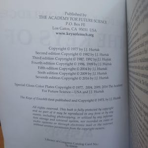May include: Open book page with text detailing publication information. The text includes the publisher, The Academy For Future Science, copyright dates, and ISBN numbers. The book's title is "The Keys of Enoch".