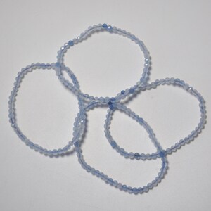 May include: Four light blue beaded bracelets made of faceted gemstone beads.