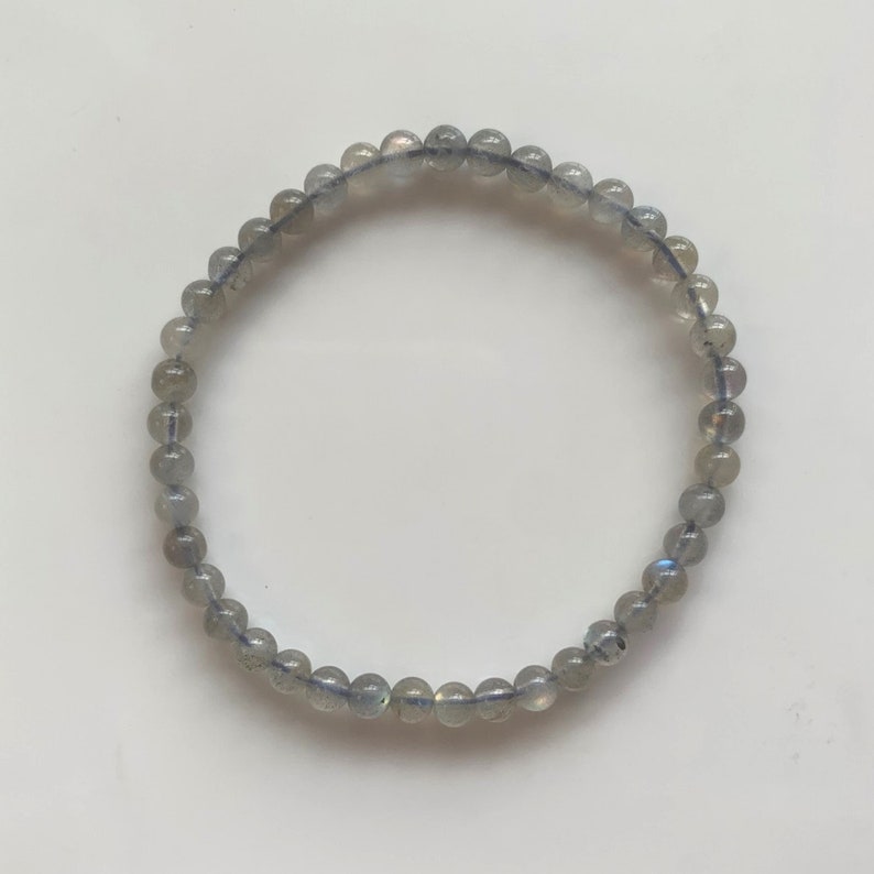 May include: A grey beaded bracelet made of labradorite stones.