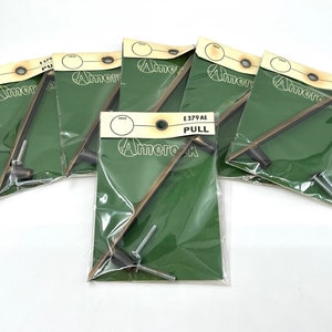 May include: Five individual packs of antique brass cabinet pulls, each with a green background and the text "Amerock E379 AE PULL" printed on the front.