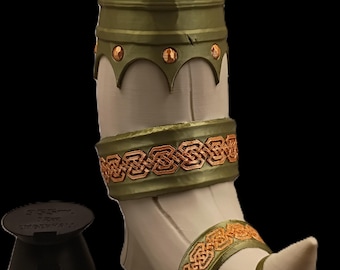 May include: A decorative beer horn with a green and gold design. The horn is cream-colored with green and gold accents, and a black base. The top of the horn holds a green and silver can.