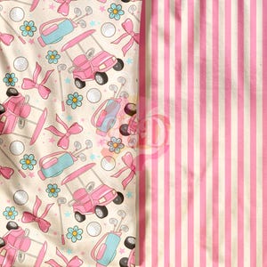 May include: Pink and white fabric with a repeating pattern of golf carts, golf clubs, golf balls, and flowers. The fabric is paired with a pink and white striped fabric.