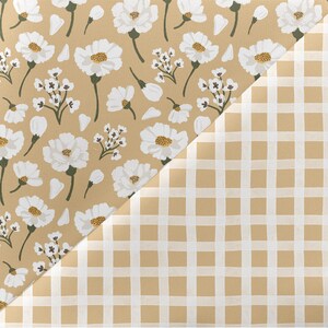 May include: A beige and white patterned fabric with a white gingham pattern on the bottom half. The floral pattern features white flowers on a beige background.