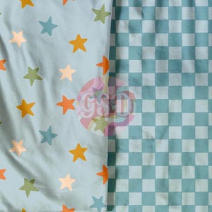 May include: A blue fabric with a pattern of orange, yellow, and green stars on one side and a blue and white checkered pattern on the other side.