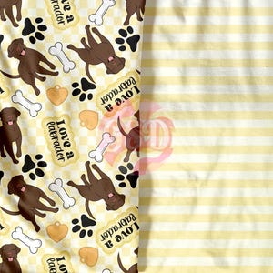 May include: A yellow and white checked fabric with a repeating pattern of chocolate brown labrador retrievers, paw prints, bones, hearts, and the text "Love a Labrador".