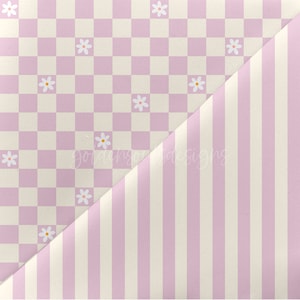 May include: A purple and white checkered fabric with a pattern of white daisies. The fabric is folded in half, revealing a purple and white striped fabric underneath.