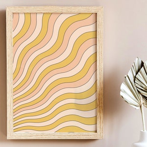 May include: A framed print with a retro-style design of wavy lines in shades of yellow and pink.