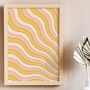 May include: A framed print with a retro-style abstract design featuring wavy lines in shades of yellow, pink, and white.