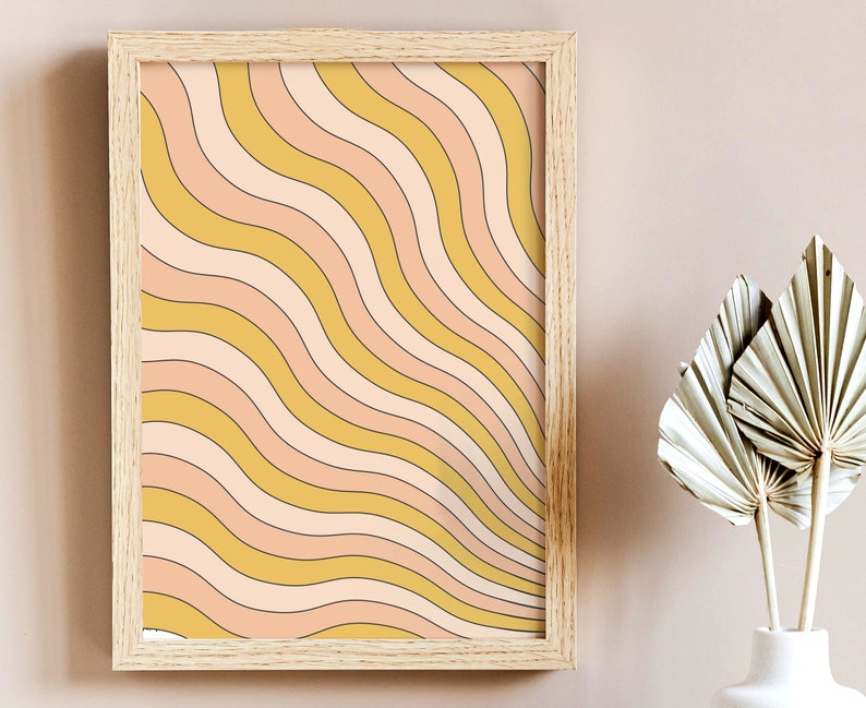 May include: A framed print with a retro-style abstract design featuring wavy lines in shades of yellow, pink, and white.