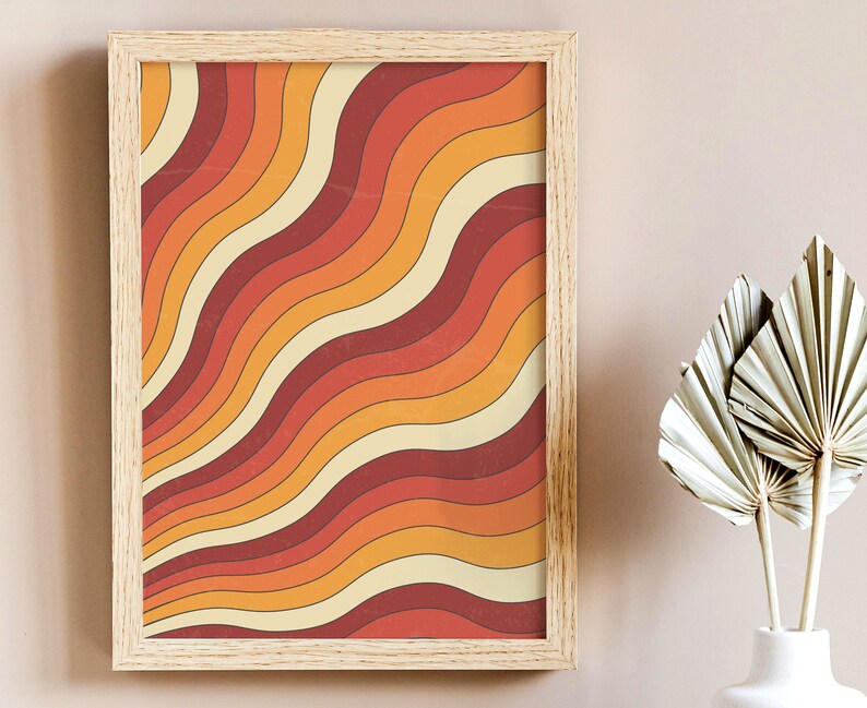 May include: A framed print with a retro design featuring wavy lines in shades of orange, red, and yellow.