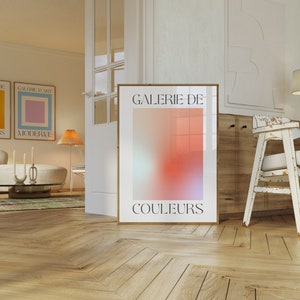 May include: A poster with a gradient of pink, orange, and blue colours. The poster has the text "GALERIE DE COULEURS" in black.