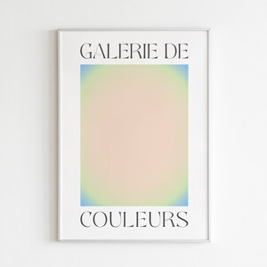 May include: A framed poster with the text "GALERIE DE COULOURS" in black font on a white background. The poster features a gradient of blue, yellow, and pink colors.
