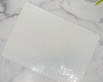 May include: A white blank jigsaw puzzle with a glossy finish. The puzzle is made of thick cardboard and has a smooth surface.