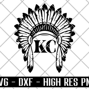 May include: Black and white silhouette of a Native American headdress with the letters "KC" in the center.