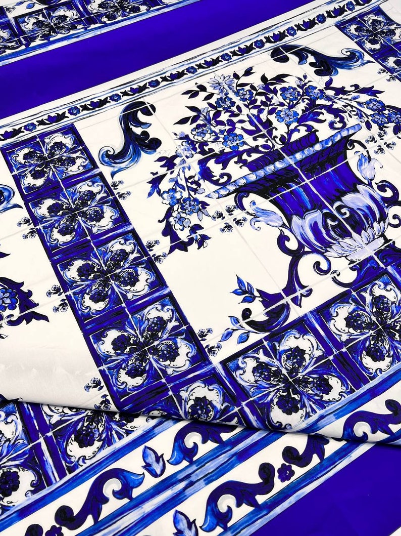 May include: Blue and white patterned fabric with a floral design. The fabric features a repeating pattern of blue and white tiles with a floral motif. The fabric is perfect for crafting, quilting, and home decor projects.