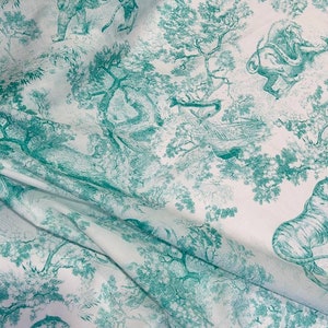 May include: White fabric with a teal toile de Jouy design featuring tigers, elephants, and other animals in a forest setting. The fabric is folded, showing the detailed pattern of trees and wildlife.