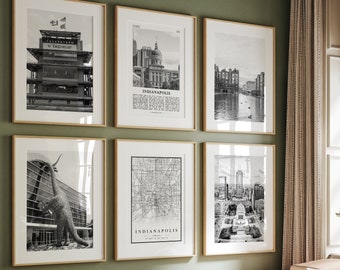 Puede incluir: Seis impresiones en blanco y negro enmarcadas de los monumentos de Indianápolis y un mapa se exhiben en una pared verde. Las impresiones incluyen el Indianapolis Motor Speedway, paisajes urbanos y un mapa de la ciudad. Los marcos son dorados y la habitación tiene una estética moderna.