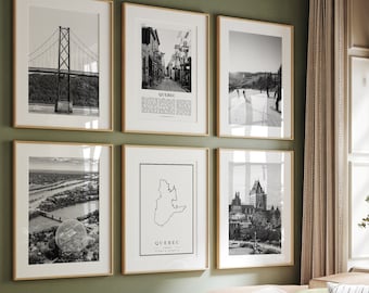 May include: A living room with a light green wall and a light brown couch with a green and white striped throw blanket. There are six black and white framed pictures on the wall, including a map of Quebec, a bridge, and a city skyline.