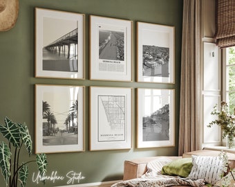 May include: A set of six framed black and white photographs of various scenes from Hermosa Beach, California. The photos include a pier, a beach, a street, a map, and a view of the coastline. The frames are all wooden and have a light brown finish.