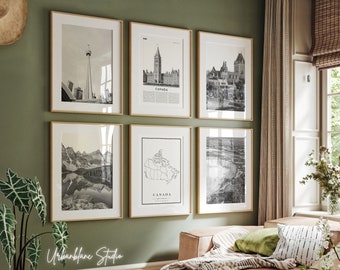 May include: A set of six black and white framed prints featuring Canadian landmarks and a map of Canada. The prints are arranged in a grid pattern on a green wall. The prints include images of the CN Tower, the Parliament Buildings, the Chateau Frontenac, the Rocky Mountains, and a map of Canada.