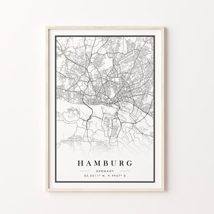 May include: A black and white map print of Hamburg, Germany, with the city name and coordinates "53.5511&deg; N, 9.9937&deg; E" printed below the map.