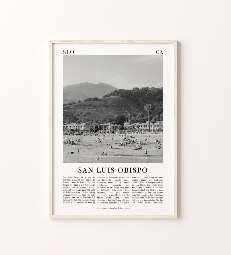 May include: Black and white photograph of a beach scene in San Luis Obispo, California. The photo shows a beach with people, houses, and a mountain in the background. The text "San Luis Obispo" is printed below the image.