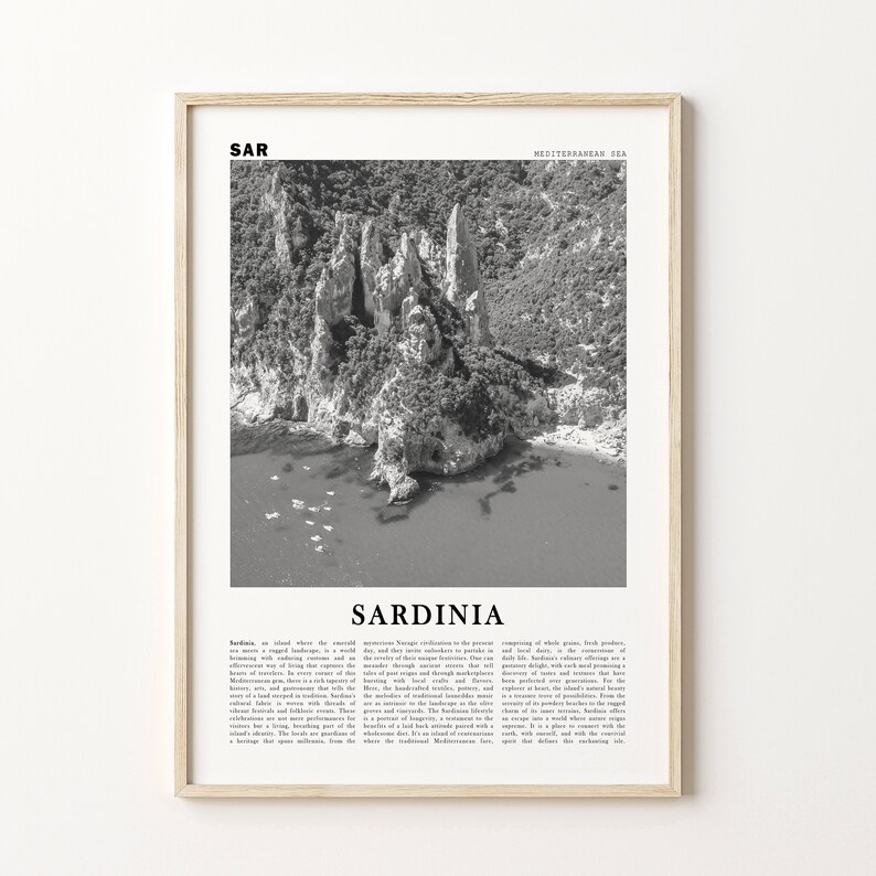 May include: A black and white photo of a rocky coastline in Sardinia, Italy. The image is framed with a light wood frame and includes the text "Sardinia" and "Mediterranean Sea".