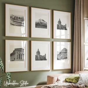 May include: A set of six black and white framed photographs of various architectural structures. The frames are a light wood color and are arranged in a grid pattern on a green wall.