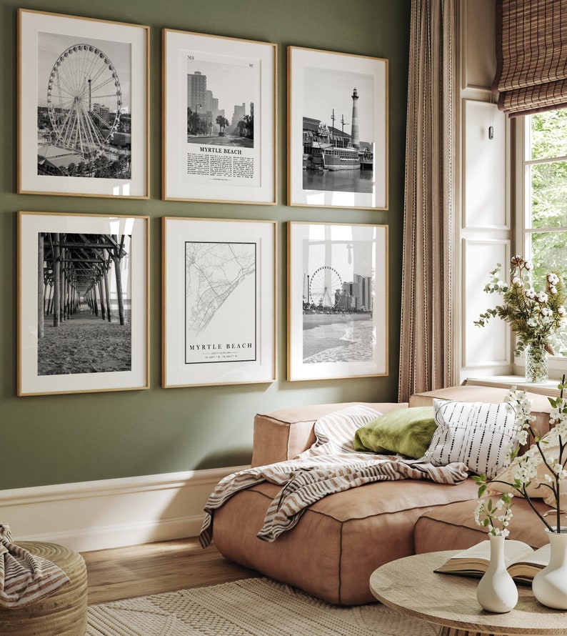May include: A living room with a green wall and a light brown couch. There are six black and white framed photos on the wall, each depicting a different scene from Myrtle Beach, South Carolina. The photos include a Ferris wheel, a pier, a map of the city, and a boat.