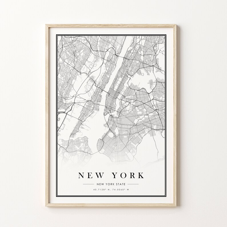 May include: Framed black and white map print of New York City and New York State. The map shows detailed street layouts and geographical features. The print includes the text "NEW YORK" and coordinates.